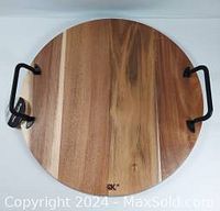 Top view of the round Acacia serving board showing natural wood grain and Craft Kitchen logo.