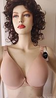 Front view of a nude La Vie En Rose sleekback bra on a mannequin showing smooth molded cups and adjustable straps with tags.