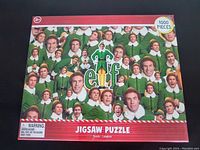 Front of puzzle box showing 1000 pieces and Elf movie design