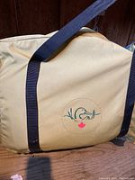 Storage bag for the inflatable canoe displaying the duck logo and Canadian maple leaf symbol