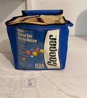 Blue soft carrying case with Cooper label and bocce set description visible.