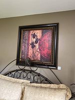 Framed wooden print hung on wall above headboard, showing overall size and style.