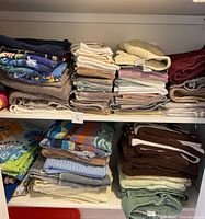 Shelves filled with folded towels in various colors and sizes.