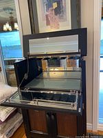 Open top view showing mirrored surface and glass holder for stemware