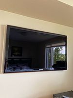 Front view of Samsung flat-screen TV mounted on wall