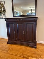 Front view of dark brown side server showing two top drawers and three cabinet doors