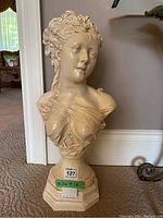 Front view of the bust sculpture showing the detailed facial features and draped cloth across chest.