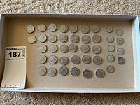 Full view of the boxed collection showing all Canadian nickels and American dimes lined up.