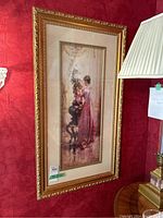 Full view of framed vertical painting showing woman arranging flowers in vase.