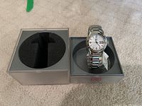 ESQ stainless steel men's watch displayed in original gray box with black foam insert on beige carpet.