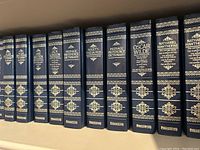 Spine view showing Peerage Books volumes including Shakespeare, Mark Twain, Jack London, Dictionaries, and Roget's Thesaurus