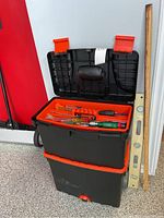 Black & Decker MasterCart toolbox in closed and open states, with measuring tools outside the box