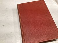 Top view of the red cloth cover of the 1945 Birds of Canada book showing wear.