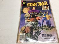 Full cover view of the Star Trek comic book showing characters, an alien being, and title text.