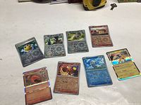 Front view of all eight shiny Pokémon cards spread out on a table.