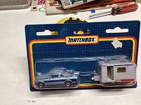 Original unopened Matchbox 1987 truck and camper set in sealed blue and black packaging.