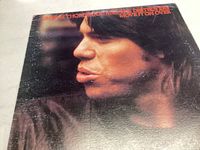 Front cover close-up photograph of George Thorogood on the album 'Move It On Over'.