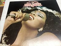 Front cover of the Live And More vinyl record by Donna Summer showing a close-up of the singer.
