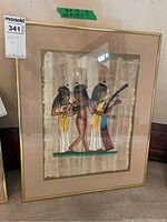 Full view of larger framed Egyptian papyrus art showing the three figures and frame dimensions label