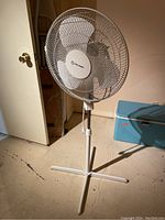 Front angle view of Pelonis oscillating fan showing entire stand and blade guard.