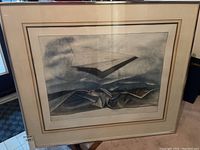 Full frontal photo of framed limited edition print showing the artwork and the surrounding off-white mat and metal frame with glass front