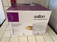 Box of Salton electric food dehydrator with image of the dehydrator and features.