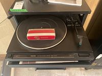 Front view of Toshiba SR-5617 belt drive turntable with record brush on platter