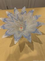 Photo of the blue and white Murano glass centerpiece showing pointed petal-like design, marbled glass pattern, and glossy finish.