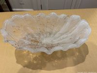 Top-down view showing the wavy ruffled edges of the bowl and gold flecks inside.