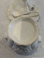 Bottom of terrine showing "Made in USA 715 C" mark and the fruit relief detail on the base rim.