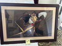 Framed artwork of Latin dancers in an abstract, geometric style with dark background and ornate costumes.