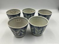 Front view showing all 5 porcelain Soba-Churu cups grouped together, featuring Yahazu arrow feather blue pattern on white porcelain.