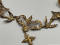 Close-up of central openwork section showing dove motif and seed pearl accents