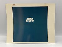 Front of photograph AS8-15-2561 showing half Earth above black background with red NASA serial number at top.