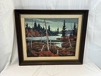 Framed full view of painting showing forest lake scene with wooden frame