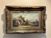 Frontal view of complete oil painting in ornate carved gilt frame hanging on wall