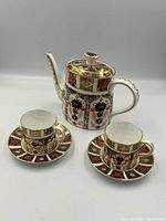 Full set showing teapot, two cups and two saucers arranged