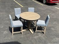 Full set of round table and four chairs viewed on pavement
