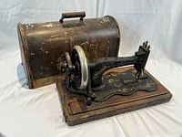 Overall view of sewing machine with metal carrying case