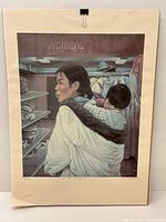 Full photo of the framed print showing woman carrying child on back with clothing racks in background.