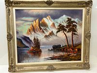 Full view of the framed oil painting showing mountain peaks, trees, water, and sky.
