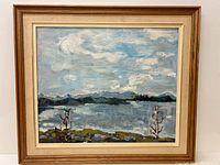 Framed impressionistic oil landscape painting of lake and mountains with trees.