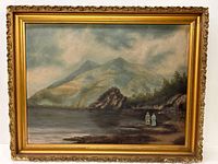 Framed painting showing a large mountain under cloudy sky, rocky shore, and two small figures near water