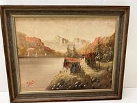 Framed oil painting showing the entire landscape scene with signature in lower left corner.