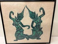 Framed Thai ink drawing showing two traditional dancers in black and green ink on beige background.