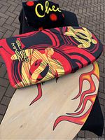 Photo showing wooden skim board and Island Magic boogie board with colorful turtle designs