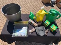 Large silver planting pot and PaperPots package on a black tablecloth.