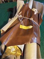 Rolled tanned deer hide with yellow tag indicating lot number