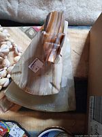 Close-up photo of single marble ashtray with elephant figure trunk up, base and elephant detailed with striated marble patterns.