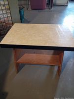 Full view of the retro side table showing wood bottom, shelf, and Arborite laminated top surface.